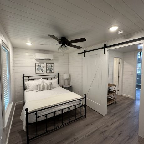 The cozy interior of a one-bedroom tiny home cabin, featuring modern furnishings and all the comforts of home at Chuck’s RV Resort in Mabank, TX.